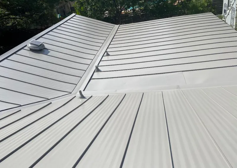 Solar attic fan installed on a metal roof for Roof Ventilation in Hillside